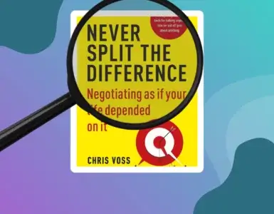 a magnifying glass overt the top of popular sales tactics book "Never Split the Difference" by chris voss